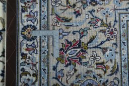 Backside of handmade 2000s Kashan rug showing knot structure and weave density