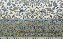 Corner detail of 2000s Kashan rug showing border pattern and Wool pile