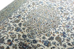 Backside of handmade 2000s Kashan rug showing knot structure and weave density