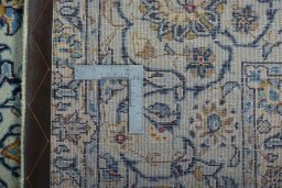 Backside of handmade 2000s Kashan rug showing knot structure and weave density