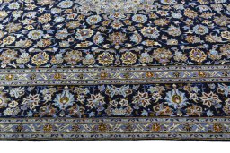 Corner detail of 2000s Kashan rug showing border pattern and Wool pile