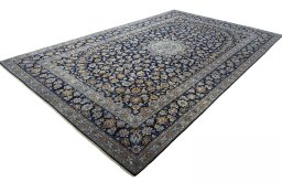 Corner detail of 2000s Kashan rug showing border pattern and Wool pile
