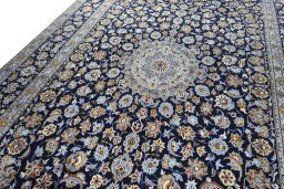 Backside of handmade 2000s Kashan rug showing knot structure and weave density
