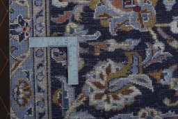 Backside of handmade 1970s Kashan rug showing knot structure and weave density
