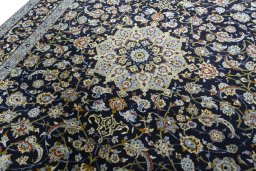 Backside of handmade 1970s Kashan rug showing knot structure and weave density