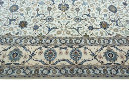 Corner detail of 2000s Kashan rug showing border pattern and Wool pile