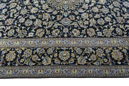Corner detail of New Kashan rug showing border pattern and Wool pile
