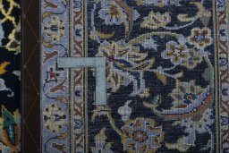 Backside of handmade New Kashan rug showing knot structure and weave density