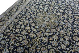 Backside of handmade New Kashan rug showing knot structure and weave density