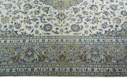 Corner detail of 2000s Kashan rug showing border pattern and Wool pile