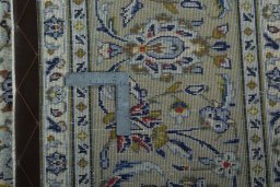 Backside of handmade 2000s Kashan rug showing knot structure and weave density