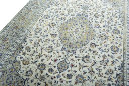 Backside of handmade 2000s Kashan rug showing knot structure and weave density
