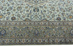 Corner detail of 2000s Kashan rug showing border pattern and Wool pile