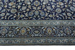 Corner detail of 2000s Kashan rug showing border pattern and Wool pile