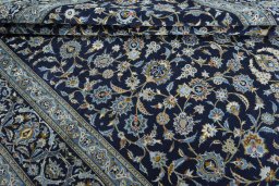 Close-up detail of 2000s Kashan rug from Iran / Persia showing Wool weave