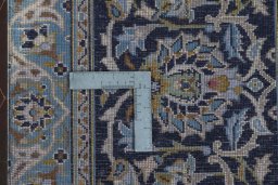 Backside of handmade 2000s Kashan rug showing knot structure and weave density