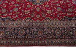 Corner detail of 2000s Kashan rug showing border pattern and Wool pile