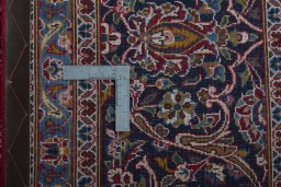 Backside of handmade 2000s Kashan rug showing knot structure and weave density