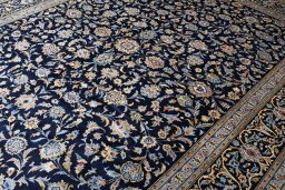 Corner detail of 2000s Kashan rug showing border pattern and Wool pile