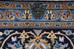 Backside of handmade 2000s Kashan rug showing knot structure and weave density