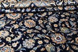 Corner detail of 2000s Kashan rug showing border pattern and Wool pile