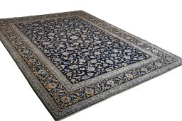 Corner detail of 2000s Kashan rug showing border pattern and Wool pile