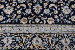 Backside of handmade 2000s Kashan rug showing knot structure and weave density