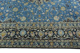 Corner detail of 2000s Kashan rug showing border pattern and Wool pile