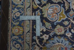 Backside of handmade 2000s Kashan rug showing knot structure and weave density