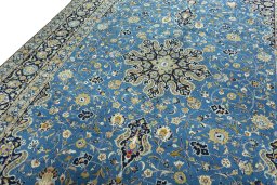 Backside of handmade 2000s Kashan rug showing knot structure and weave density