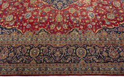 Corner detail of 2000s Kashan rug showing border pattern and Wool pile