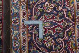 Backside of handmade 2000s Kashan rug showing knot structure and weave density
