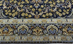Corner detail of 2000s Kashan rug showing border pattern and Wool pile