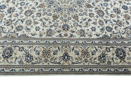 Corner detail of 2000s Kashan rug showing border pattern and Wool pile