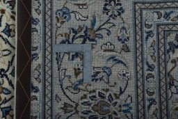 Backside of handmade 2000s Kashan rug showing knot structure and weave density