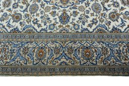 Corner detail of 2000s Kashan rug showing border pattern and Wool pile