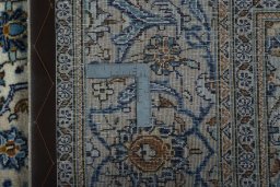 Backside of handmade 2000s Kashan rug showing knot structure and weave density