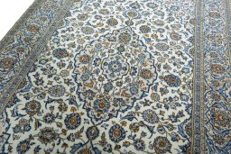 Backside of handmade 2000s Kashan rug showing knot structure and weave density