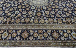Corner detail of 2000s Kashan rug showing border pattern and Wool pile