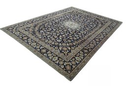 Corner detail of 2000s Kashan rug showing border pattern and Wool pile