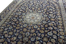 Backside of handmade 2000s Kashan rug showing knot structure and weave density