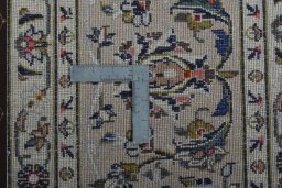Backside of handmade 2000s Kashan rug showing knot structure and weave density