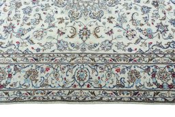 Corner detail of 2000s Kashan rug showing border pattern and Wool pile
