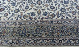 Corner detail of 2000s Kashan rug showing border pattern and Wool pile