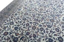 Backside of handmade 2000s Kashan rug showing knot structure and weave density