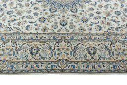 Corner detail of 2000s Kashan rug showing border pattern and Wool pile