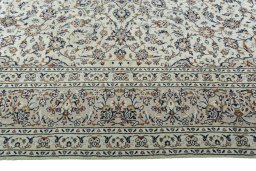 Corner detail of 2000s Kashan rug showing border pattern and Wool pile