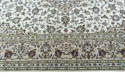 Corner detail of 2000s Kashan rug showing border pattern and Wool pile