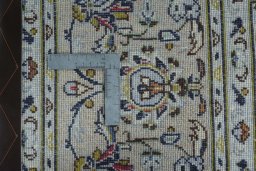 Backside of handmade 2000s Kashan rug showing knot structure and weave density