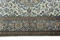 Corner detail of 2000s Kashan rug showing border pattern and Wool pile